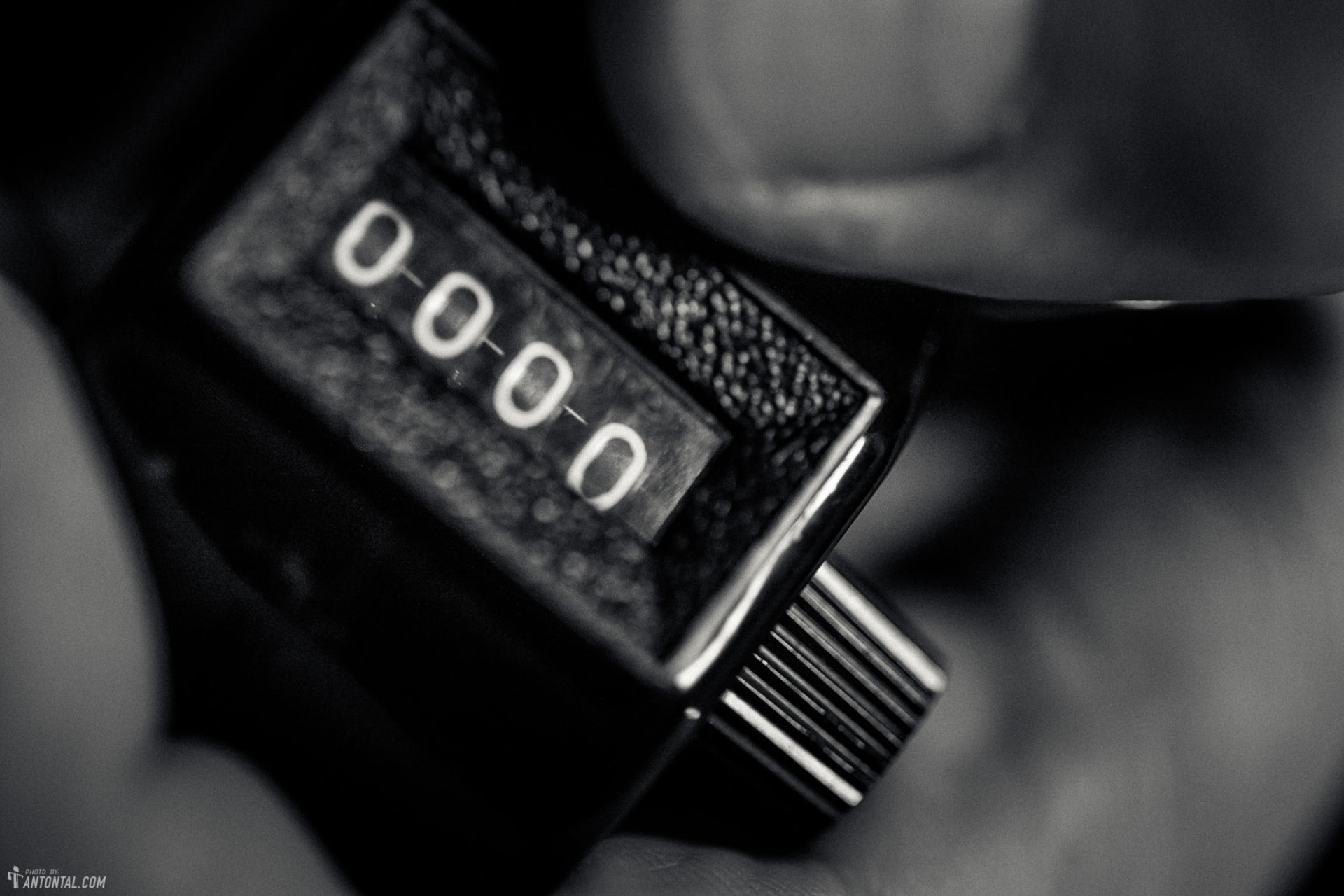 Black and white macro shot of a mechanical counter reading zeros